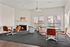 Inviting communal space with cozy fireplace, modern seating, and abundant natural light from large windows.
