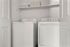 Modern laundry area featuring a sleek washer and dryer set with convenient overhead storage.