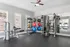 Modern gym with state-of-the-art fitness equipment, bright windows, and colorful exercise balls.