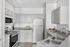 Elegant kitchen with modern appliances, sleek countertops, and ample storage in chic cabinetry.