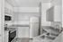Modern and bright kitchen with sleek stainless steel appliances, ample cabinetry, and elegant countertops, perfect for culinary creativity.