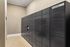 Modern parcel locker area with sleek black units in a stylish apartment building offering secure package storage.