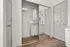 Elegant walk-in closet with mirrored sliding doors, featuring modern shelving and ample hanging space, perfect for stylish and organized living.