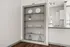 Elegant built-in shelving with modern decor, adjacent to a sleek kitchen counter, creating a stylish and open living space.