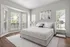 Bright and elegant bedroom with large bay windows, modern furnishings, and tranquil decor.