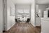 Bright dining nook with modern round table, four sleek chairs, and large window illuminating elegant hardwood floors.