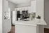 Modern kitchen with sleek stainless steel appliances, elegant white cabinetry, and stylish open-concept countertops.
