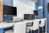 Modern communal iLounge with sleek computer stations, ergonomic chairs, and stylish decor for a comfortable and productive environment.