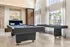 Luxurious recreation room featuring a modern pool table, elegant seating, and large windows with serene outdoor views.