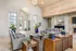 Elegant living area with high ceilings, stylish chandeliers, modern furniture, and vibrant decor pieces, perfect for relaxation and entertaining.