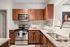 Modern kitchen with sleek granite countertops, stainless steel appliances, and rich wooden cabinets for a luxurious feel.