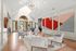 Elegant modern lounge with high ceilings, chic seating, and vibrant geometric wall art.