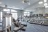 Bright and modern fitness center with state-of-the-art equipment, mirrored walls, and ample natural light.
