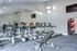 Modern fitness center with state-of-the-art treadmills, exercise bikes, and yoga balls in a bright, spacious setting.