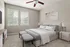 Bright and cozy bedroom with modern furnishings, featuring a plush bed, elegant side tables, and large windows inviting natural light and serene views.