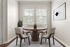 Charming dining nook with a round wooden table, modern chairs, and natural light highlighting elegant decor.