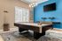 Chic apartment game room featuring a modern pool table, stylish lighting, and large window with serene outdoor views.
