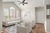 Bright and inviting living room with elegant neutral decor, high ceiling, and large arched windows allowing abundant natural light.