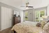 Bright and cozy bedroom with large windows, stylish decor, and a comfortable bed in a serene ambiance.