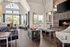 Luxurious living room with vaulted ceilings, large arched windows, elegant fireplace, and contemporary seating, perfect for a stylish and bright living space.