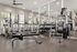 Modern fitness center equipped with state-of-the-art exercise machines, including treadmills, weights, and strength training equipment, ideal for a dynamic workout experience.