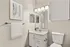 Elegant bathroom with modern fixtures, featuring a sleek white vanity, contemporary lighting, and artistic wall decor.
