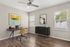 Chic and modern home office with sleek wooden desk, vibrant yellow chair, and elegant art on the walls, radiating a warm and productive atmosphere.