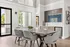 Bright dining area with modern design, elegant gray chairs, and stunning wall art, featuring large windows letting in natural light.