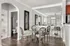 Elegant dining area with a glass table and stylish chairs, featuring contemporary wall art and a well-lit mirrored wall for enhanced ambiance.