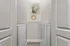 Sleek and modern laundry room with front-load washer and dryer, complemented by minimalist art and soft lighting.