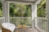 Charming balcony with cozy seating and lush green views, perfect for serene relaxation.
