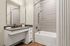 Elegant bathroom with modern fixtures, sleek vanity, and inviting bathtub for a luxurious experience.