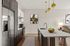 Chic modern kitchen with stainless steel appliances, elegant pendant lighting, and a stylish island, perfect for entertaining.