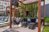 Inviting outdoor lounge area with chic pergolas, modern seating, and stylish side tables, perfect for relaxation and entertainment.