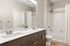 Sleek, modern bathroom featuring a double-sink vanity, inviting bathtub, and contemporary fixtures for a luxurious feel.