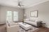 Bright and modern living room with sleek furniture, elegant decor, and welcoming natural light through large glass doors.