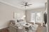 Elegant living room with modern beige sofa, stylish decor, and floor-to-ceiling windows for abundant natural light.