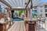 Inviting outdoor patio space with modern grills, comfortable seating, and a picturesque poolside view, perfect for entertaining.