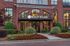Elegant front view of Wesley Village with beautiful landscaping and inviting brick architecture.