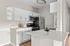 Sleek modern kitchen with pristine countertops, elegant white cabinetry, and stainless steel appliances.