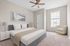 Elegant bedroom showcasing a plush king-sized bed, modern design elements, and natural light from a large window.