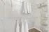 Spacious walk-in closet featuring organized shelving, hanging space, and neatly stacked storage boxes, perfect for stylish living.