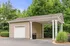 Charming covered parking structure with clean white accents surrounded by lush greenery for a serene residential experience.