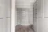 Elegant storage space featuring sleek modern cabinetry with ample shelving, complemented by stylish wood flooring.