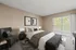 Bright and inviting bedroom with modern decor, plush bedding, and a private balcony showcasing a scenic view.