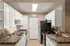 Modern kitchen with sleek countertops, white cabinetry, and stainless steel appliances in a bright, inviting space.