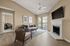 Inviting living room with cozy fireplace, modern decor, and large windows offering abundant natural light.