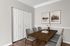Elegant dining room with modern wooden table, six stylish chairs, and contemporary artwork on freshly painted walls.