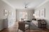 Elegant living room with modern decor, featuring a comfortable sofa, stylish armchairs, and large window letting in natural light.