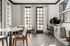 Elegant communal workspace with stylish furniture, large windows providing natural light, and modern decor.